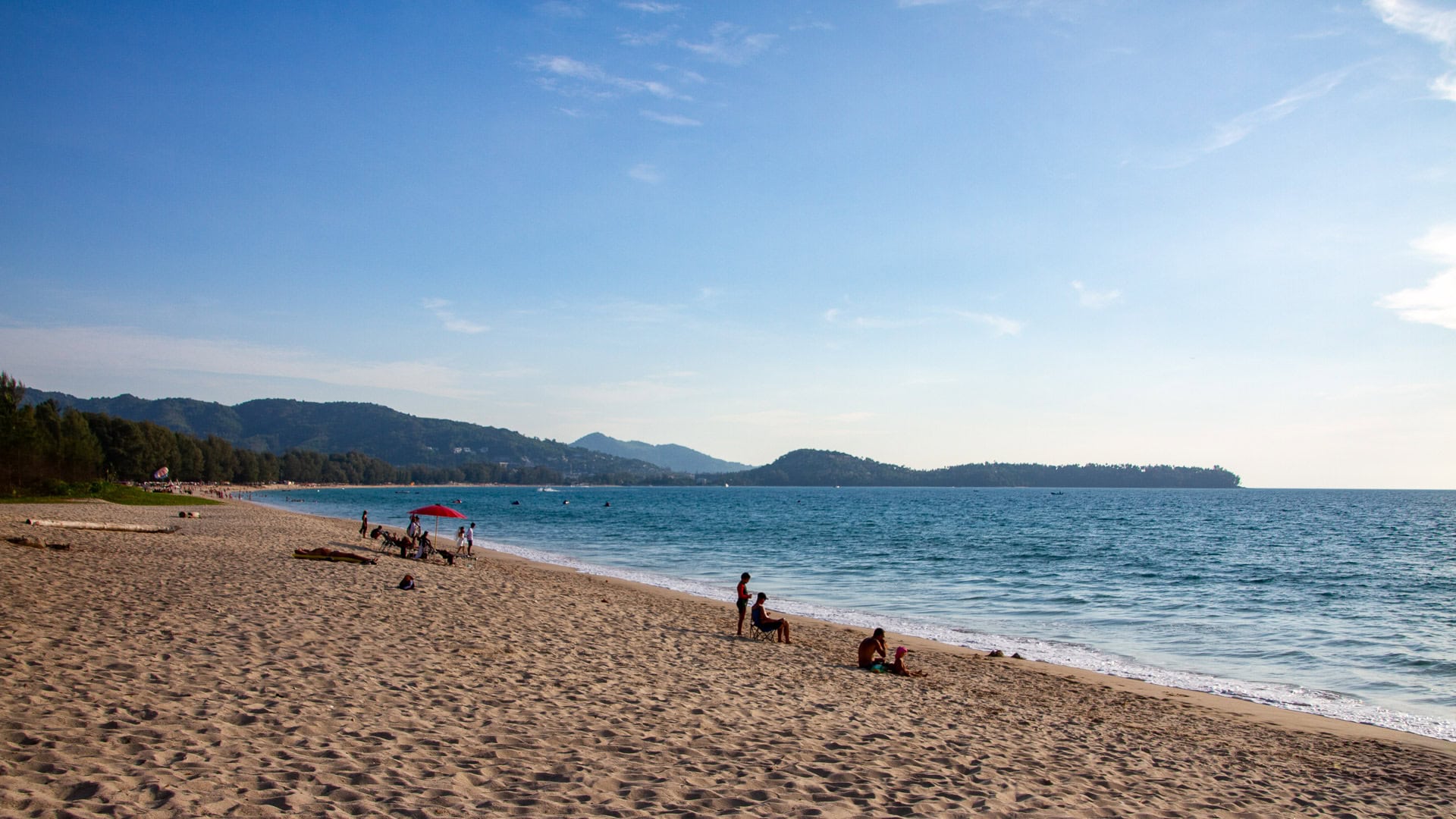 Southern Bang Tao with wide sand, gentle waves and distant headlands.