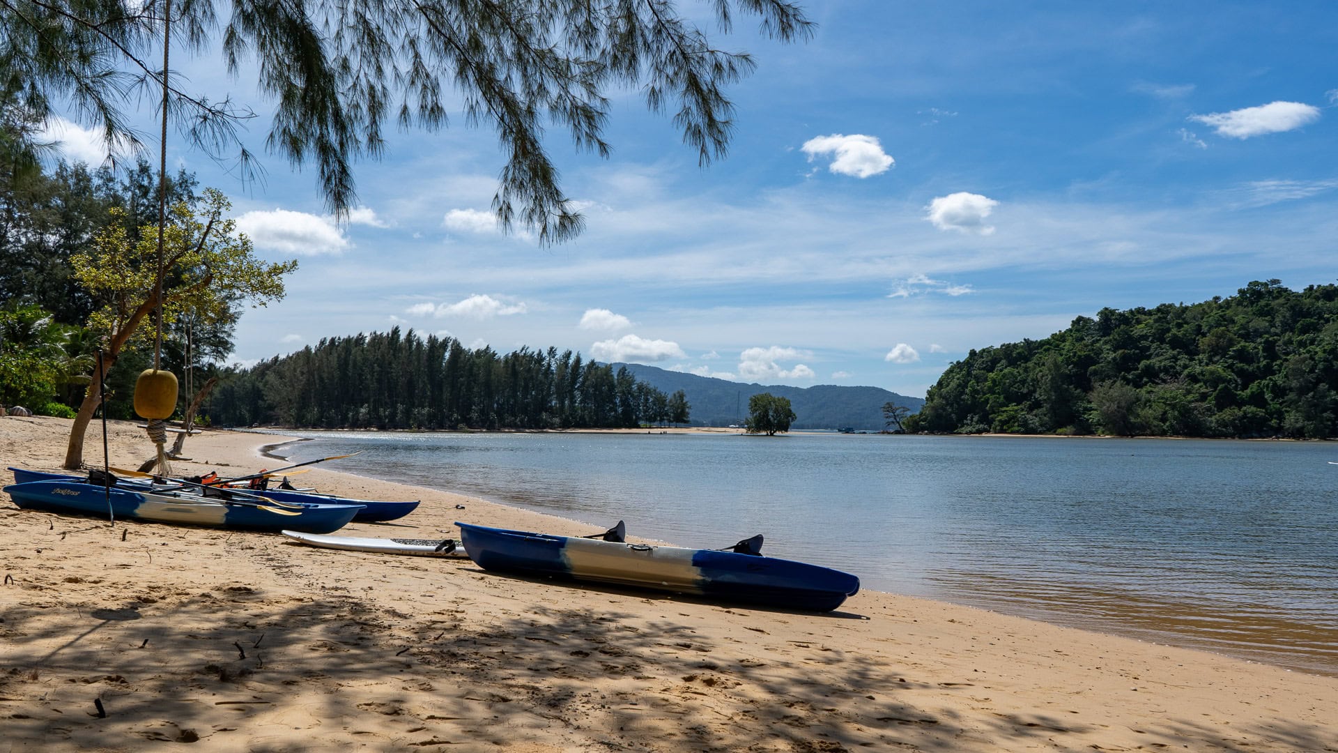 Kayaks pulled onto sand beside the protected lagoon area.