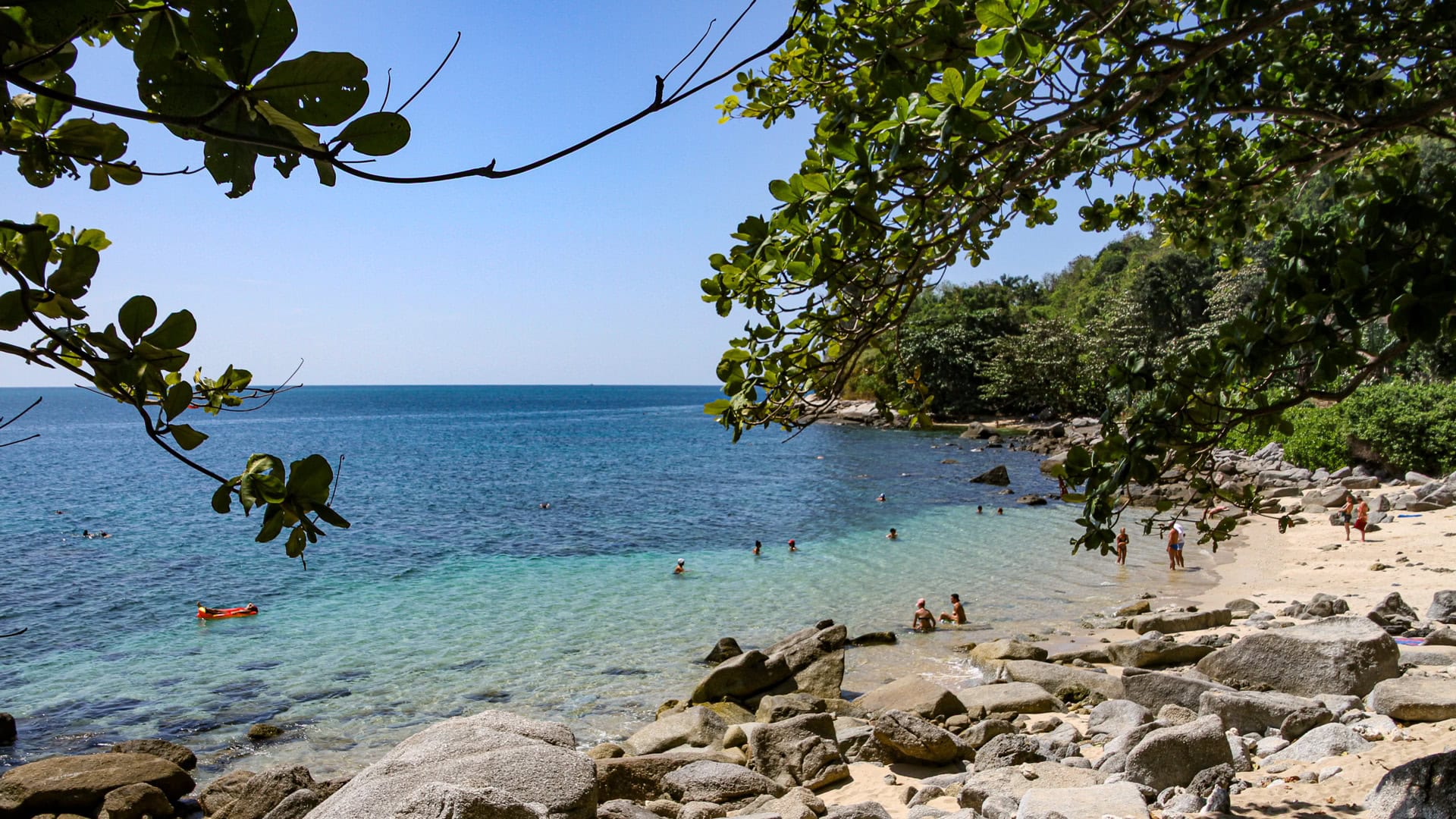 Ao Sane Beach Phuket shaded shoreline with trees framing the bay
