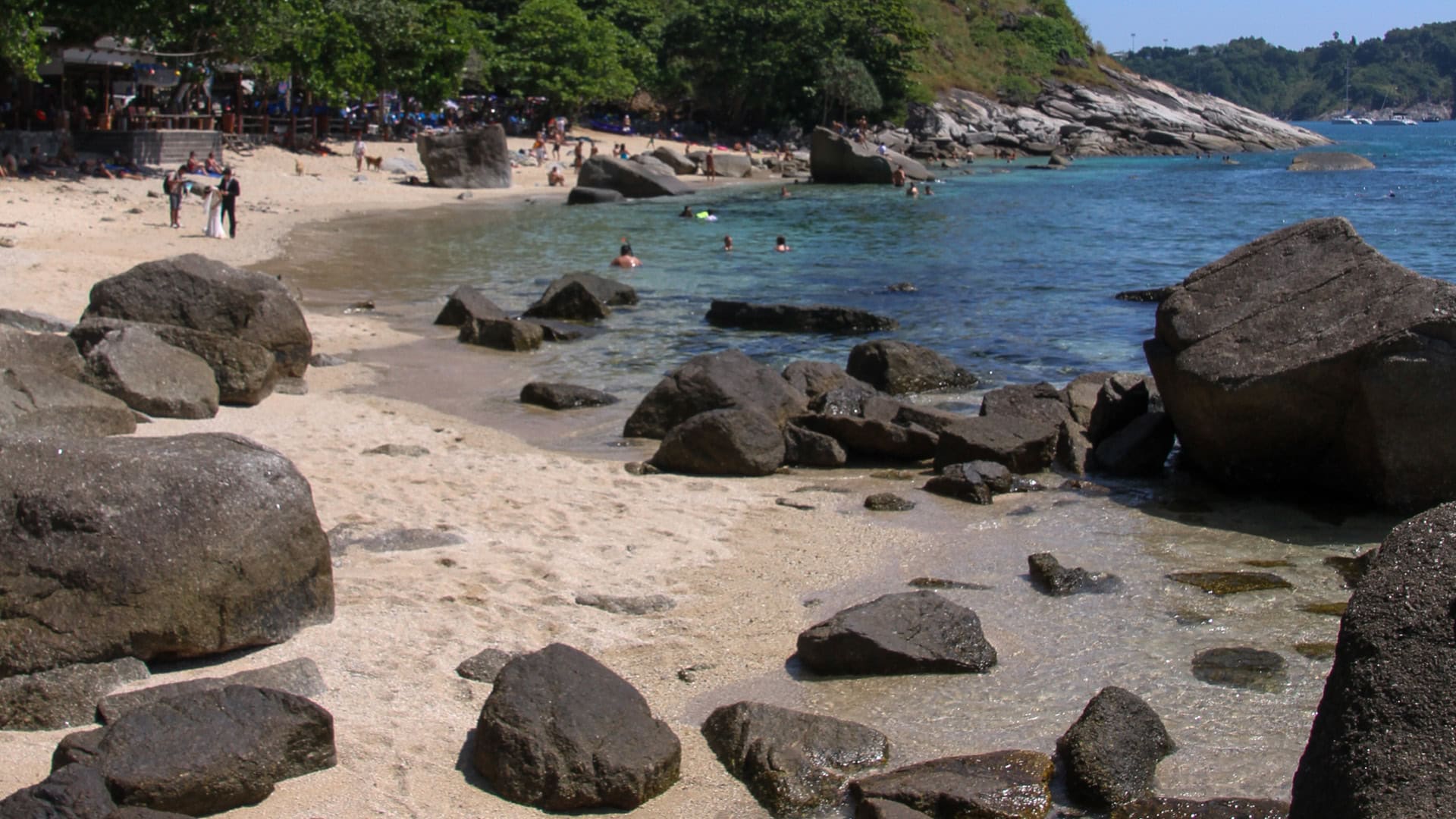 Ao Sane Beach Phuket wide view of cove with sand, rocks, and offshore hills