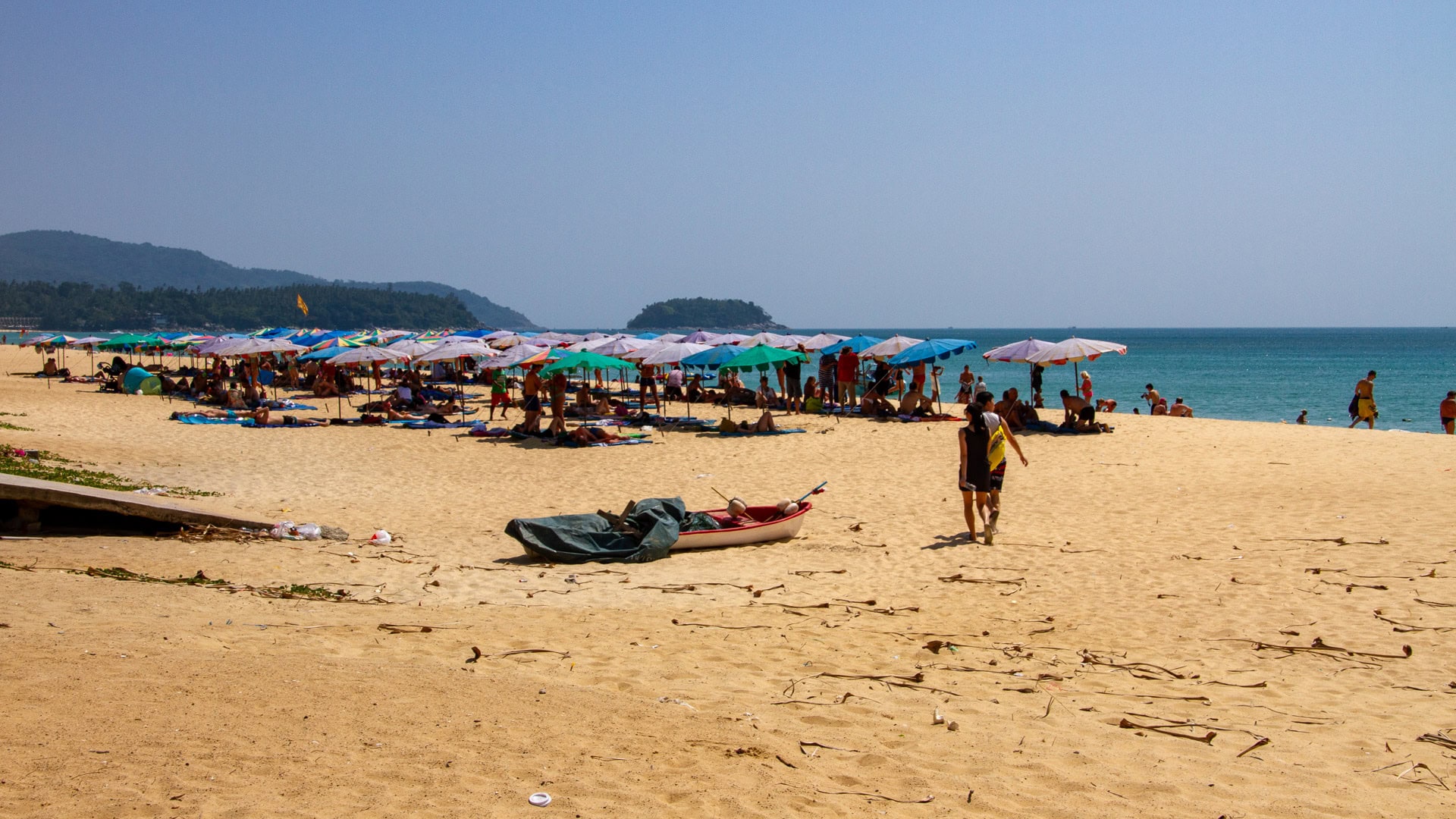 Umbrella zone at Karon Beach Phuket with people resting on the sand
