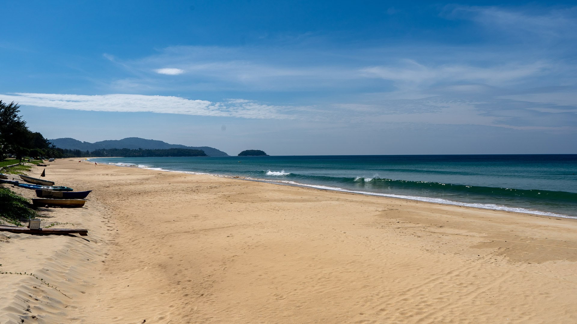 Quiet stretch of Karon Beach Phuket with small waves and open sand