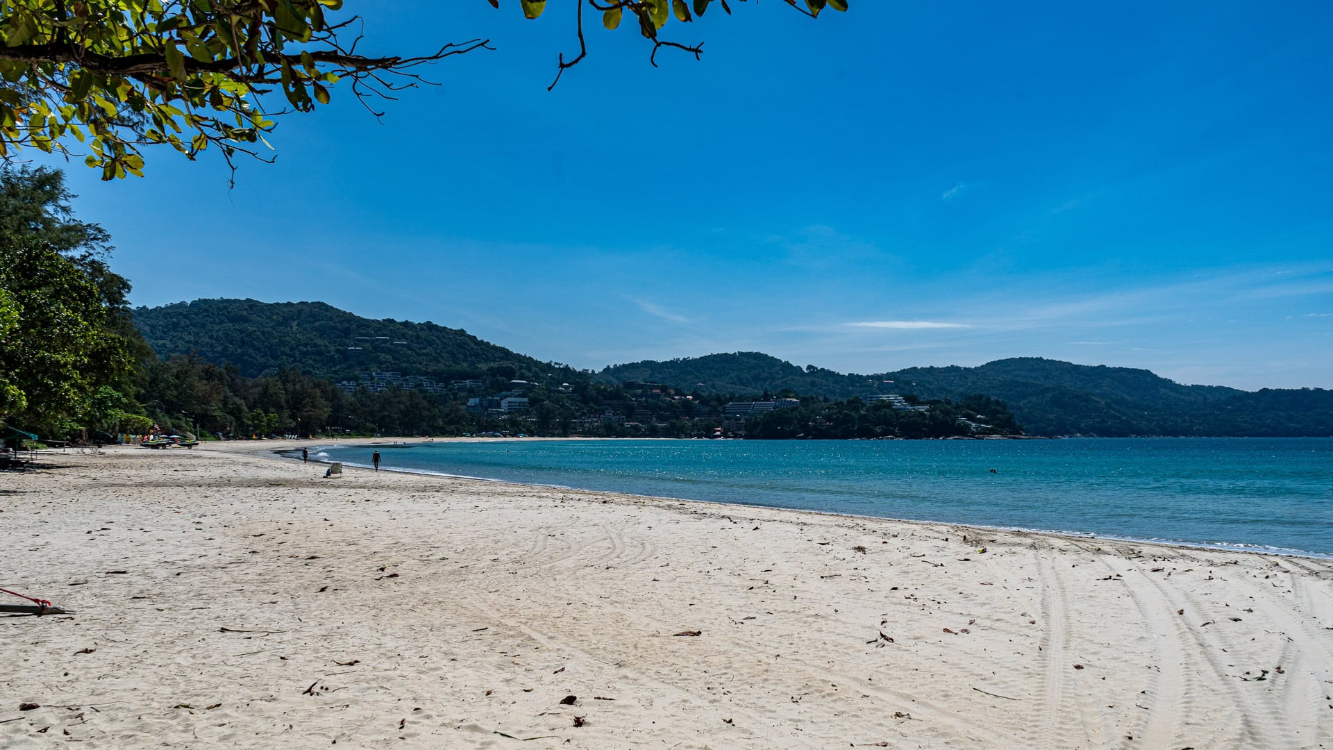 Kata Beach Phuket long empty stretch of sand with blue sea and distant hills