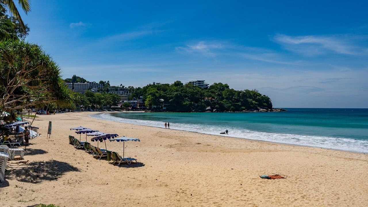 Kata Beach Phuket beach scene with sun loungers, umbrellas, and curved bay