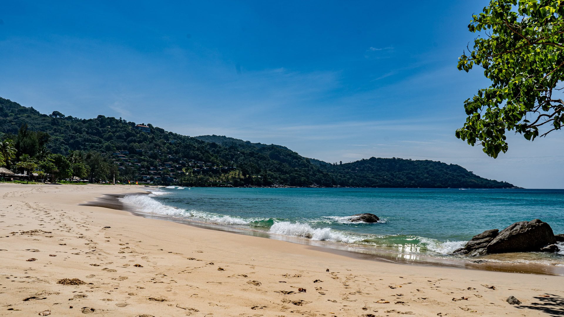 Kata Noi Beach Phuket quiet sandy stretch with small waves and distant hills