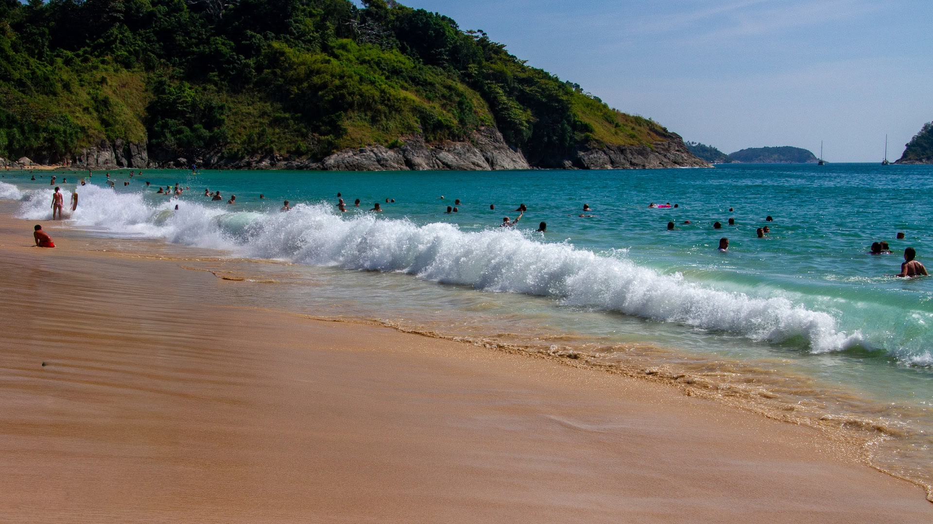 Nai Harn Beach Phuket breaking waves with people swimming offshore