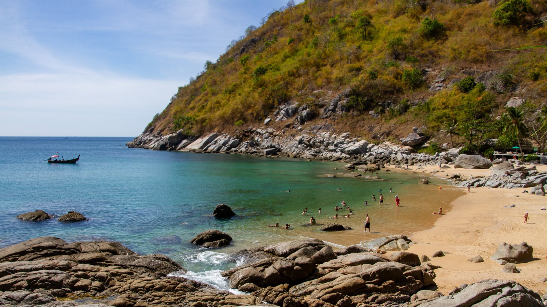 Nui Beach Phuket shallow water swimming area with rocks and hillside