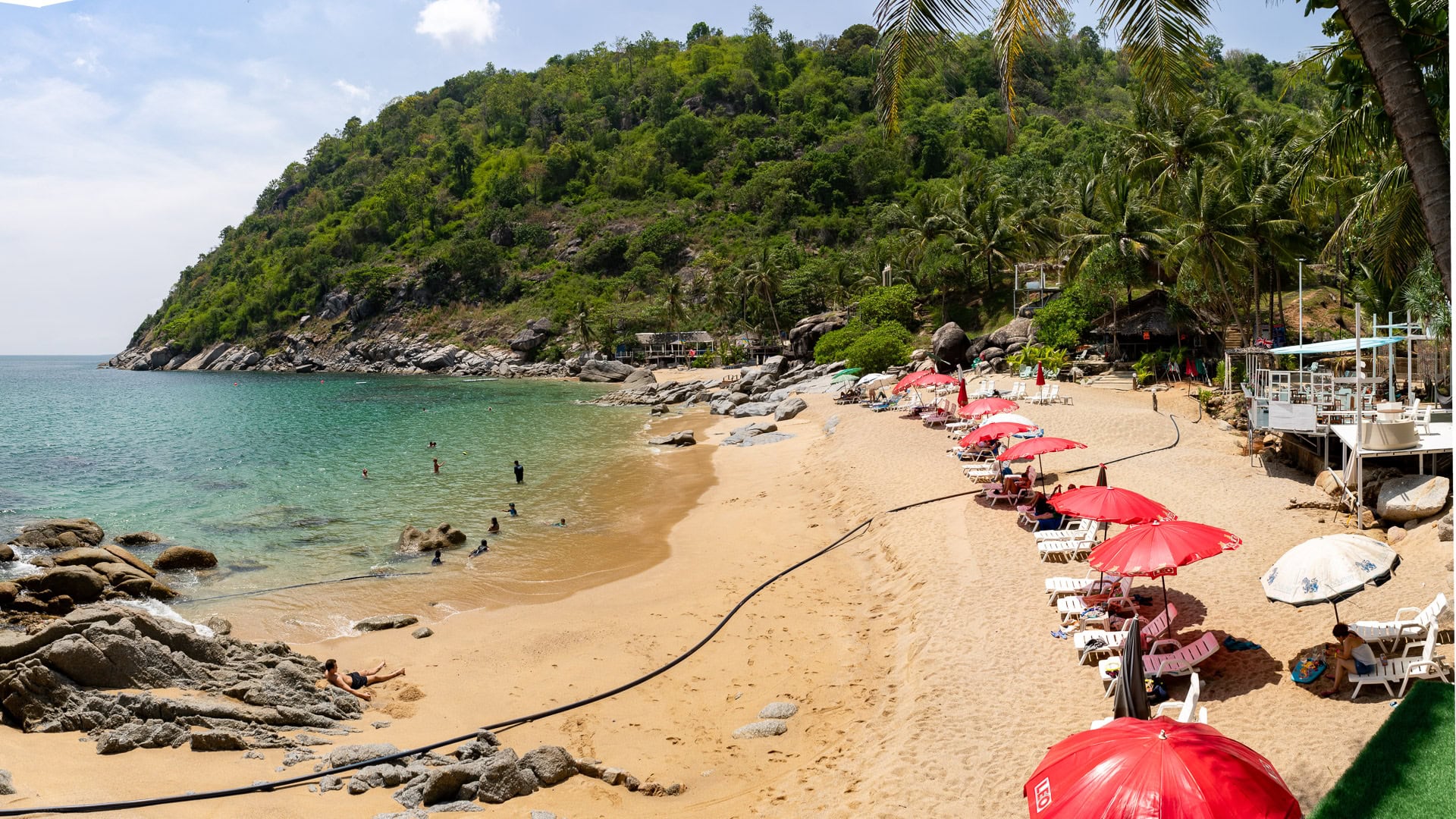 Nui Beach Phuket elevated view of cove with swimmers and rocky edges