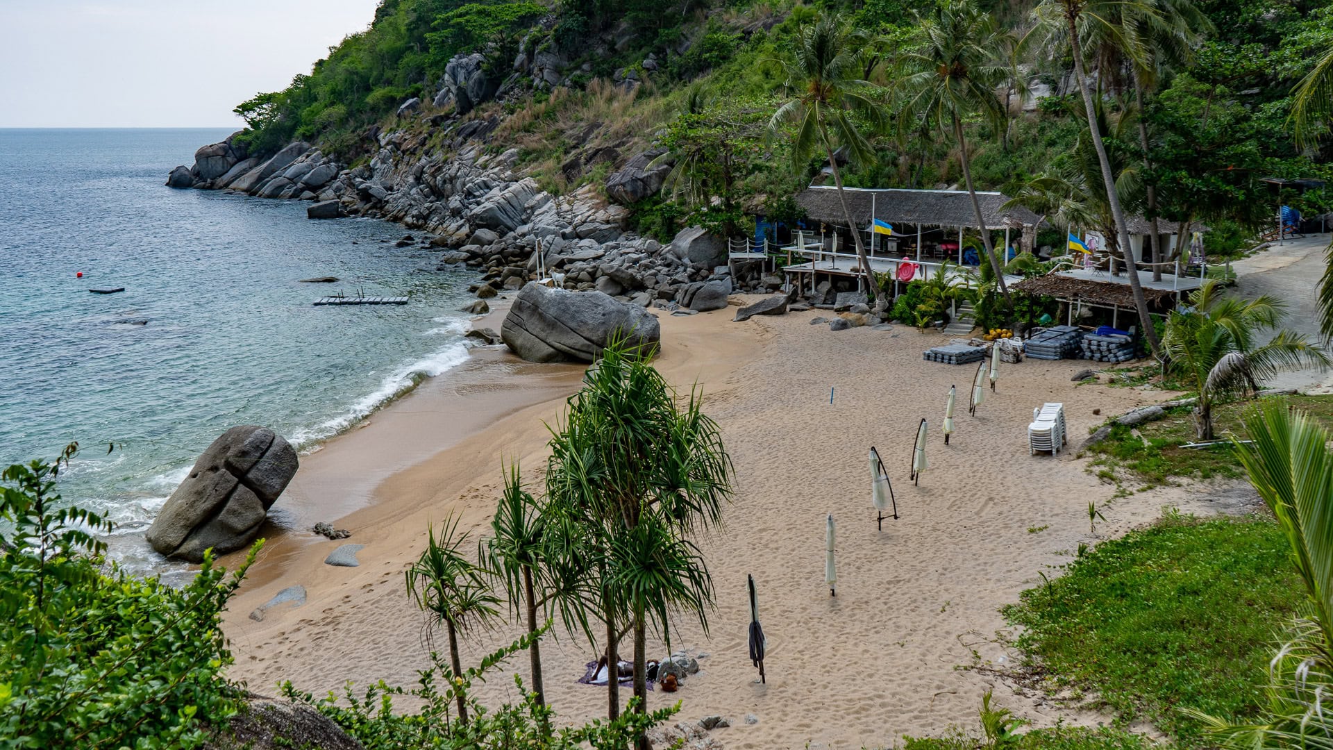 Nui Beach Phuket wide view of cove with coarse sand and green hillside