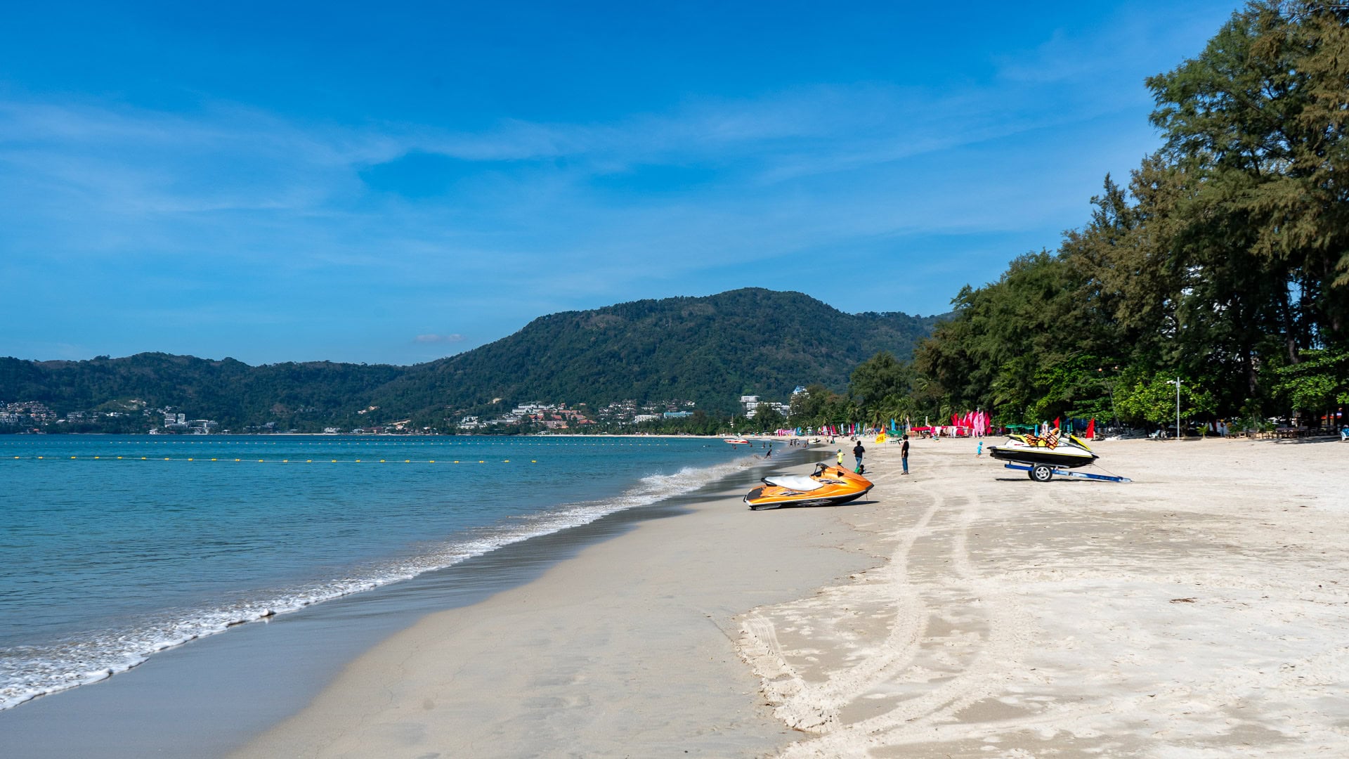 Patong Beach Phuket sandy shoreline with jet skis parked near the water