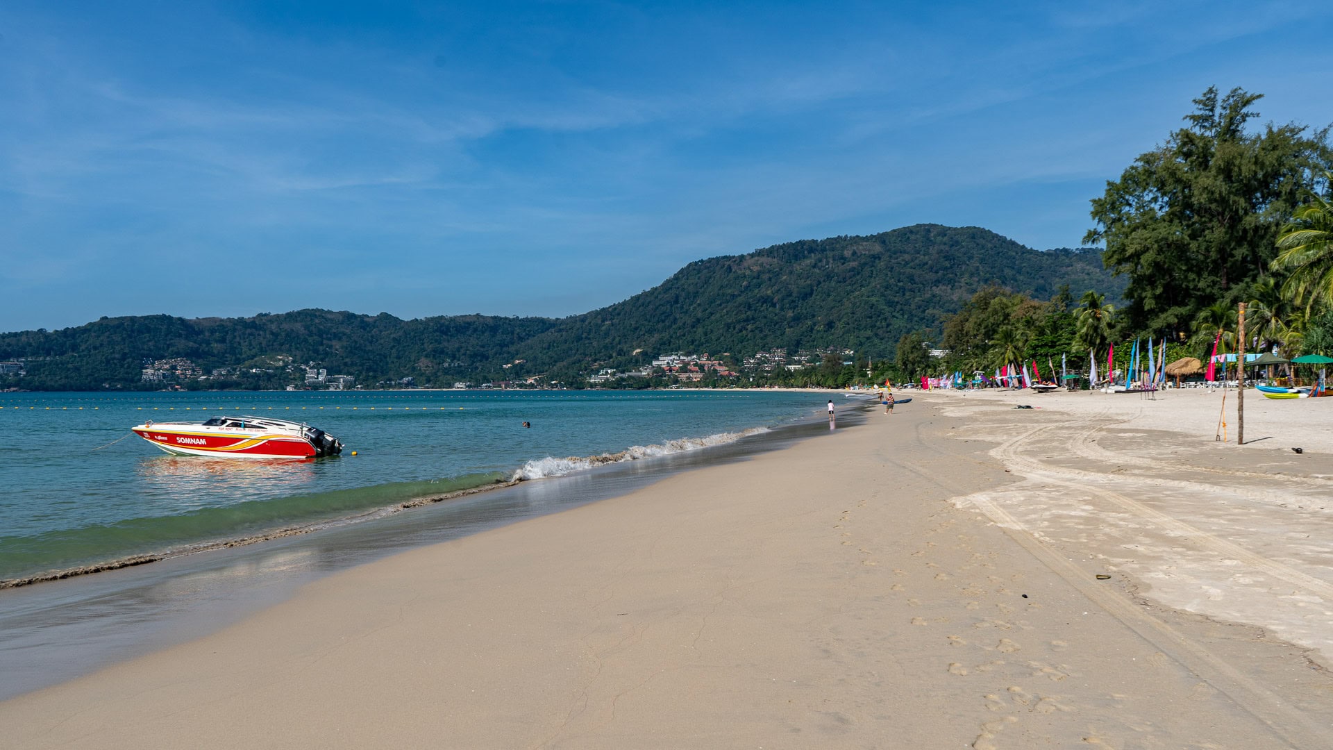 Patong Beach Phuket calm sea with speedboat anchored near shore