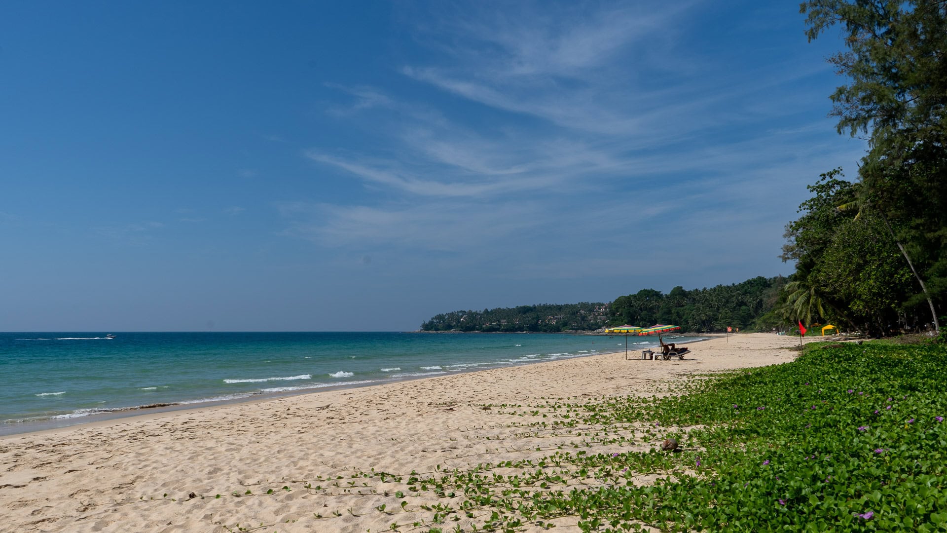 Clear, shallow water along the main curve of Surin Beach.