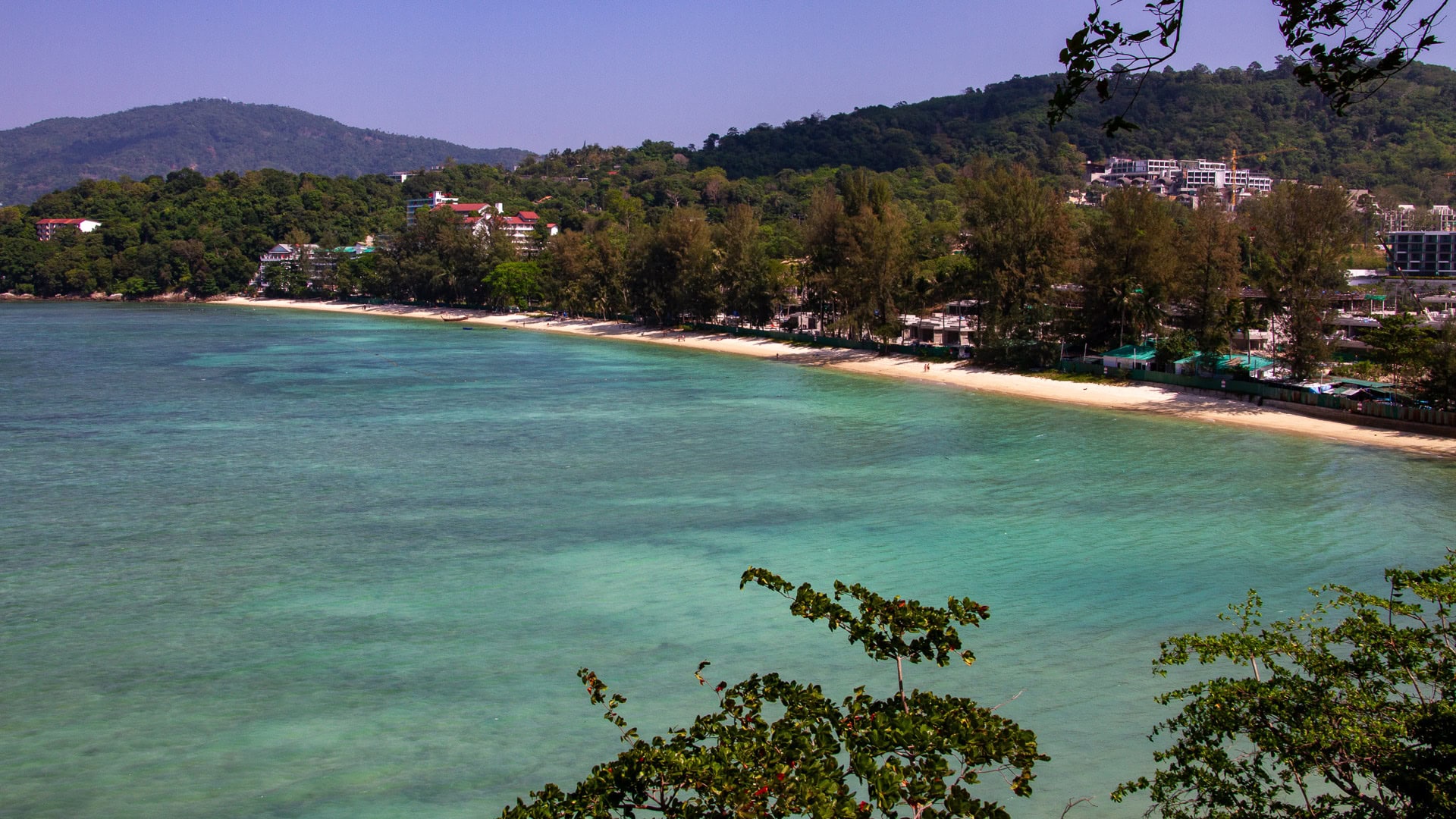 Tri Trang Beach Phuket shaded shoreline with clear shallow water