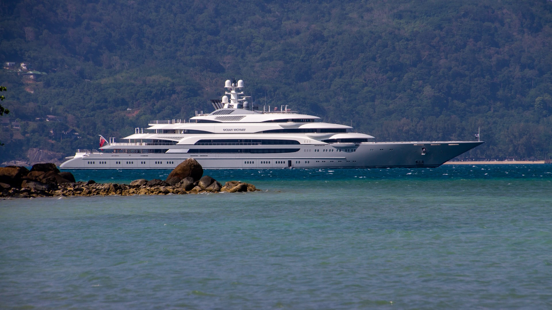 Tri Trang Beach Phuket offshore view with anchored yacht in calm sea