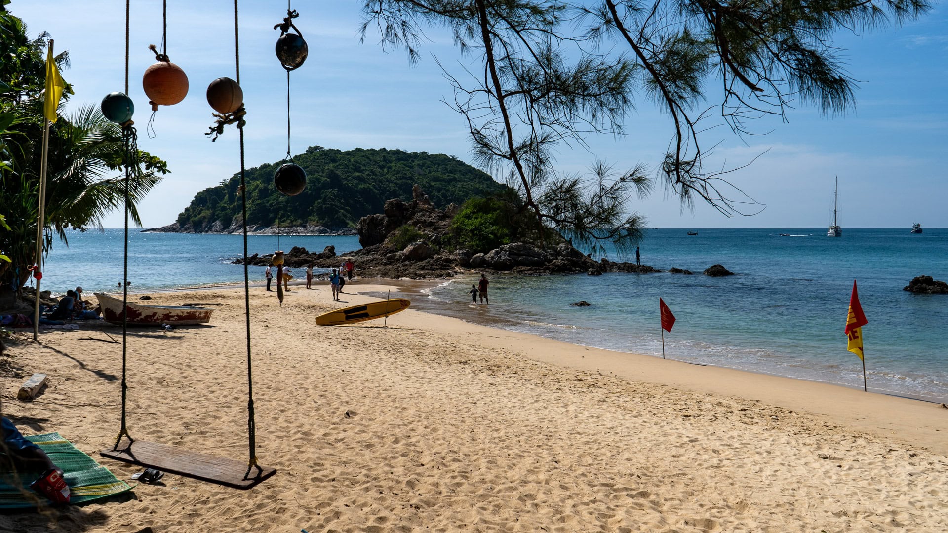 Yanui Beach Phuket beach swing and shallow water near rocky outcrop