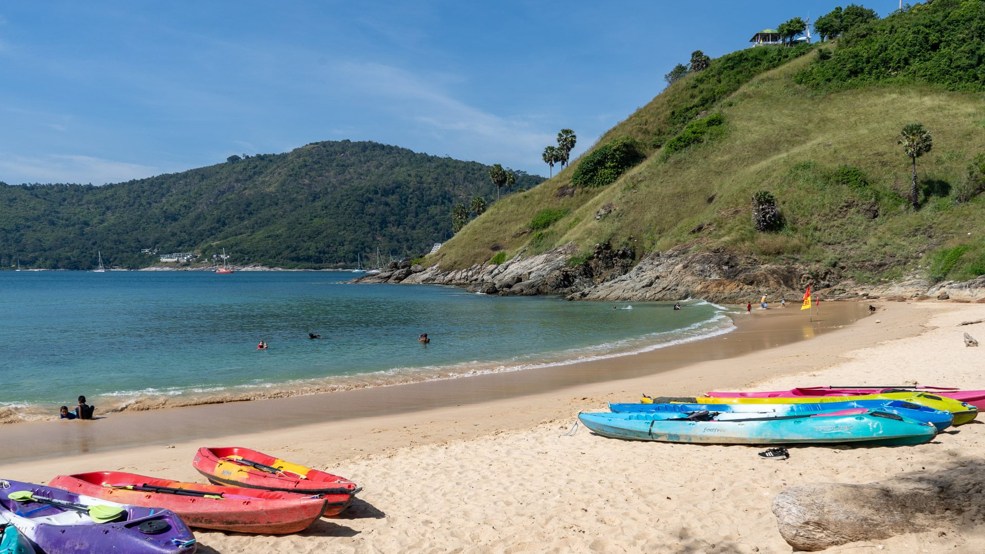 Yanui Beach Phuket calm cove with kayaks resting on sand