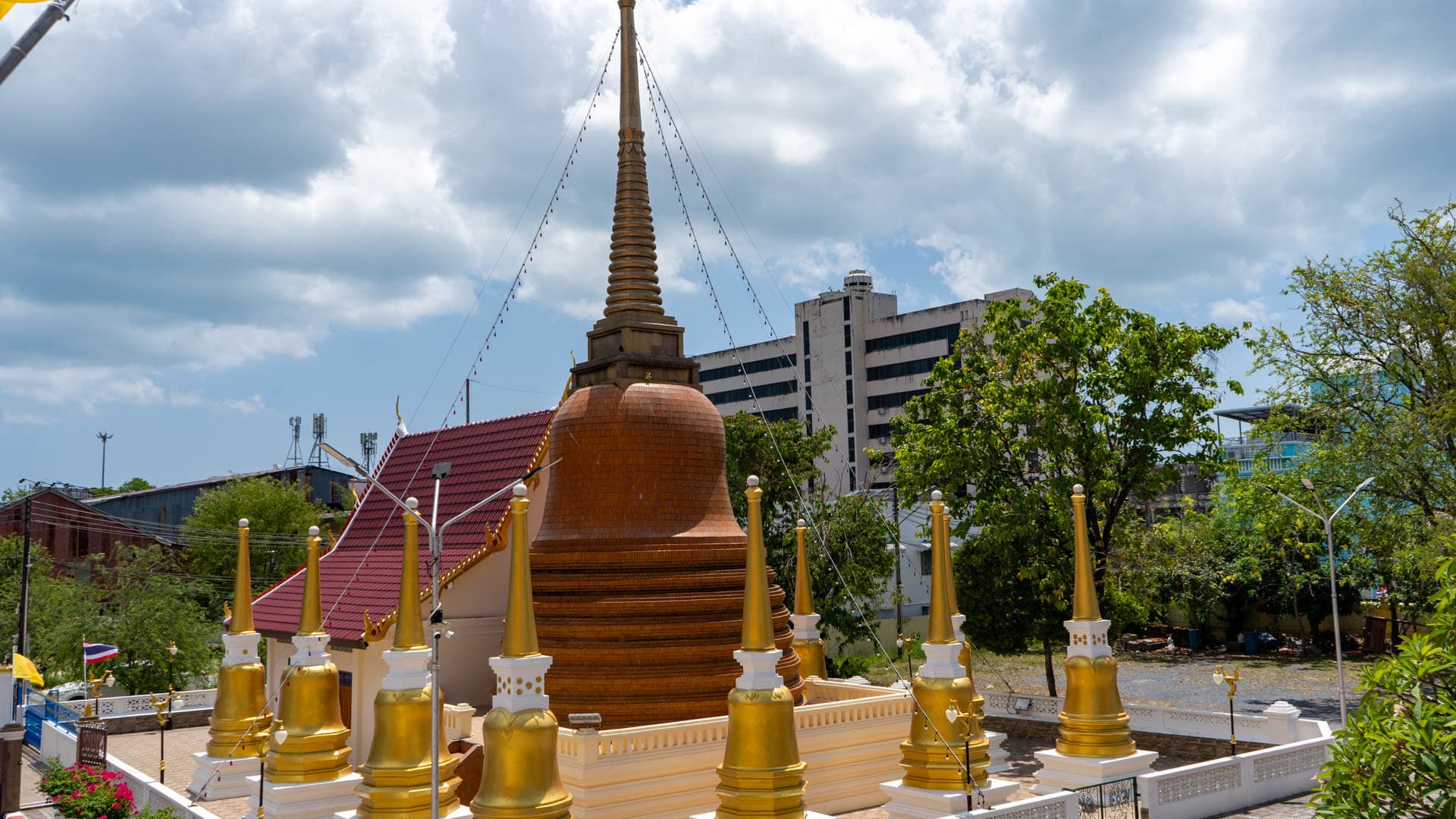 Elevated view of chedi and gilded spires inside Wat Mongkolnimit