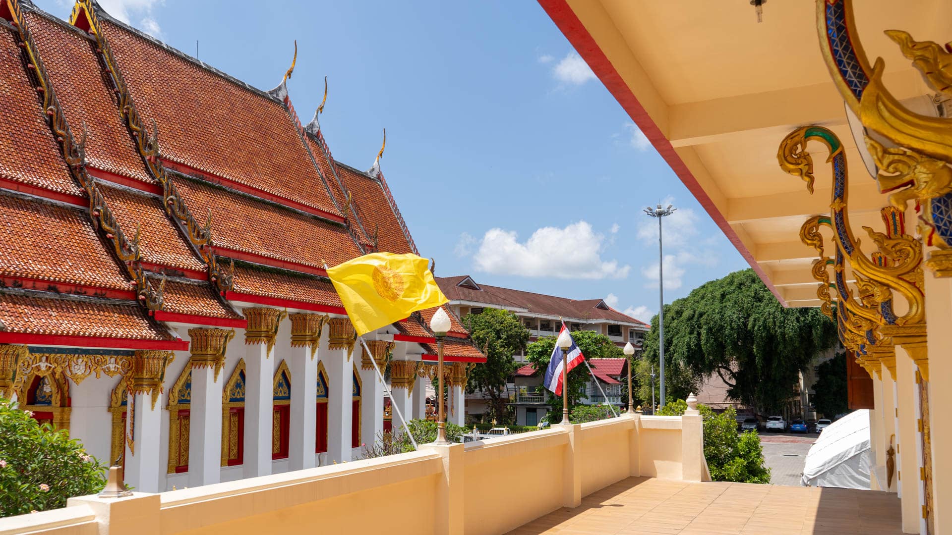 Terrace view of ordination hall and flags at Wat Mongkolnimit